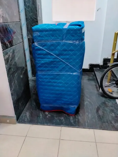 Blue wrapped cupboard – Nation Packers And Movers