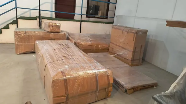 Furniture wrapped in cardboard – Nation Packers And Movers