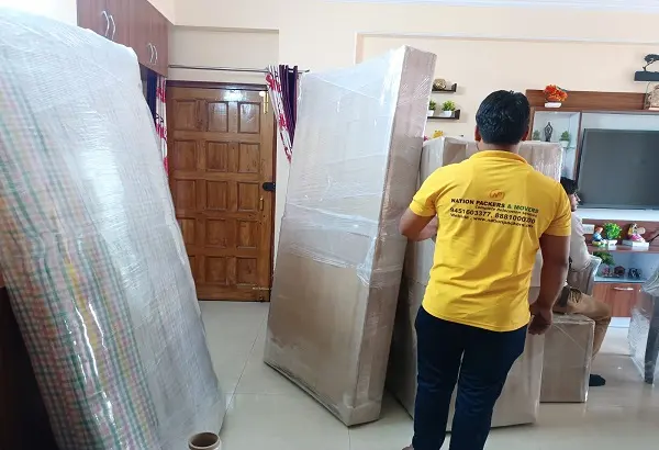 Nation Packers team moving wrapped furniture during house shifting in Lucknow